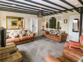 A living room with sofas and a coffee table at Ty Mawr in Criccieth