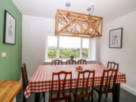 A dining room with a table and chairs at Ty Mawr in Criccieth