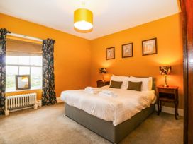 A bedroom with a bed and curtains at Ty Mawr in Criccieth
