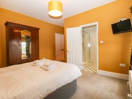 A bedroom with a bed and wardrobe at Ty Mawr in Criccieth
