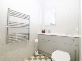 A bathroom with a sink, toilet, and towel rack at Ty Mawr in Criccieth