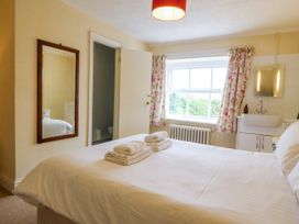 A bedroom with a bed and a sink at Ty Mawr in Criccieth
