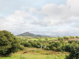 A landscape view with mountains and trees at Ty Mawr in Criccieth