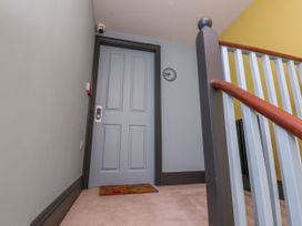 A hallway with a door and stairs at Apartment Blue in Whitby