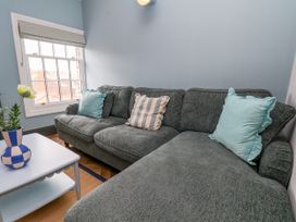 A snug with a sofa and coffee table at Apartment Blue in Whitby