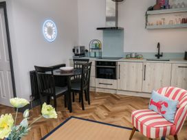 A kitchen with table and chairs at Apartment Blue in Whitby