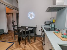 A kitchen with a dining table and chairs at Apartment Blue in Whitby