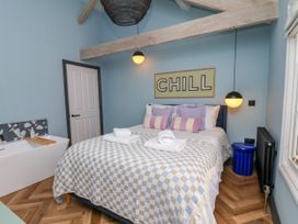 A bedroom with a bed and wash basin at Apartment Blue in Whitby