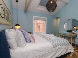 A bedroom with a bed and pillows at Apartment Blue in Whitby