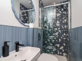 A bathroom with a shower and wash basin at Apartment Blue in Whitby