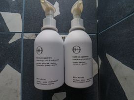 Body wash and conditioner bottles mounted in a bathroom at Apartment Blue in Whitby