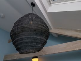 A light fixture suspended from the ceiling at Apartment Blue in Whitby