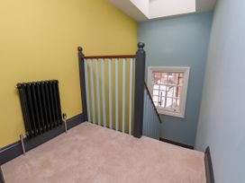 A staircase with a radiator and window at Apartment Blue in Whitby