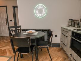 A kitchen with a table and chairs at Apartment Green in Whitby