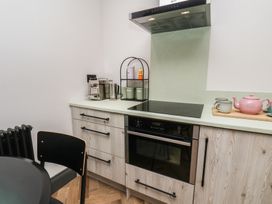 A kitchen with a stove, oven, and coffee machine at Apartment Green in Whitby
