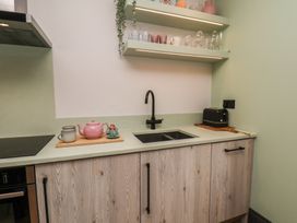 A kitchen with a sink and teapot at Apartment Green in Whitby