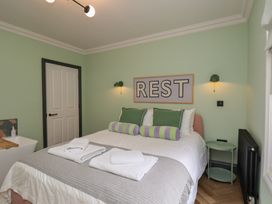 A bedroom with a bed and green accents at Apartment Green in Whitby