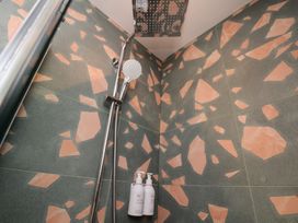 A shower with tiles and products in a bathroom at Apartment Green in Whitby