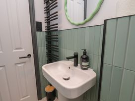 A bathroom with a sink and mirror at Apartment Green in Whitby