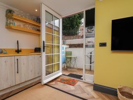 A kitchen with a counter and door leading to outdoor space at Apartment Yellow in Whitby