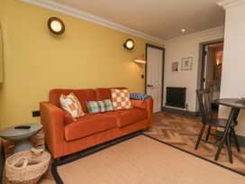 A living room with a sofa and table at Apartment Yellow in Whitby