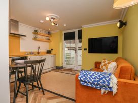 A living room with a kitchen and dining area at Apartment Yellow in Whitby