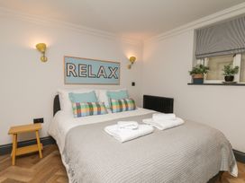A bedroom with a bed and wall art at Apartment Yellow in Whitby