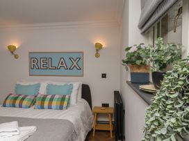 A bedroom with a bed and decorative items at Apartment Yellow in Whitby