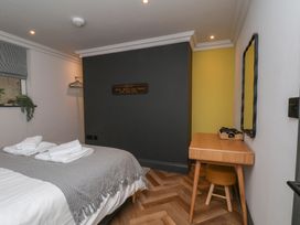 A bedroom with a bed and a desk at Apartment Yellow in Whitby