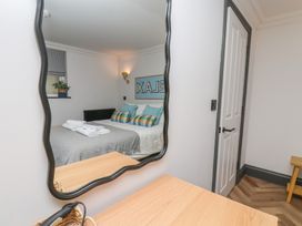 A bedroom with a bed and decorative pillows at Apartment Yellow in Whitby