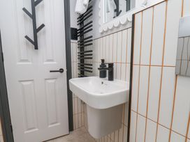 A bathroom with a sink and mirror at Apartment Yellow in Whitby