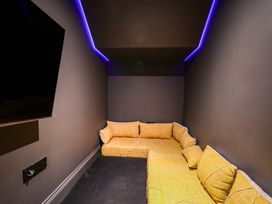 A home theater with a sectional sofa and a television at Apartment Yellow in Whitby