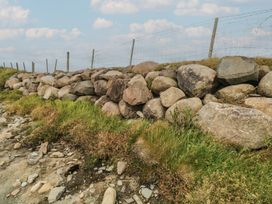 A stone wall with fence and grass at Islands Inn in Louisburgh, County Mayo