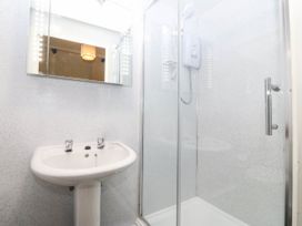 A bathroom with a sink and shower at Bwthyn Bach in Pentrefelin