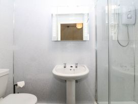 A bathroom with a sink, toilet, and shower at Bwthyn Bach in Pentrefelin