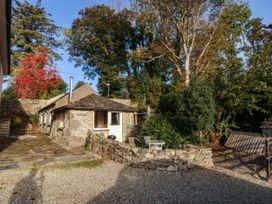 An outdoor area with a stone building and pathway at Bwthyn Bach in Pentrefelin