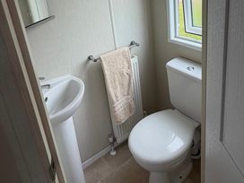 A bathroom with a sink and toilet at Trecco Bay holiday park, Porthcawl