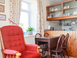 A dining room with armchair and table in Chyancrowse Penzance