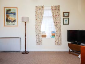 A living room with a window and television at Chyancrowse in Penzance