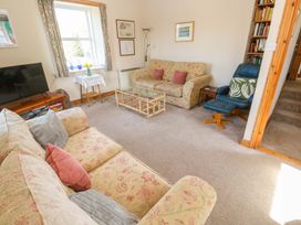 A living room with a sofa and television at Chyandaunce in Penzance