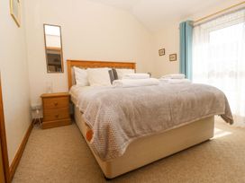 A bedroom with a bed and nightstand at Chyandaunce in Penzance