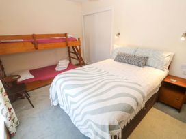 A bedroom with a bunk bed and a double bed at Chyandaunce in Penzance