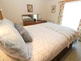 A bedroom with a bed and dresser at Chyandaunce in Penzance