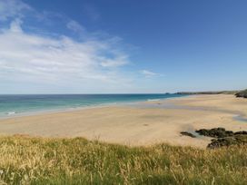 A beach with sand and water at Roslenn in St Agnes