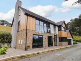 A modern house with stone and wood features at The Barn at Bryn Eithin Colwyn Bay