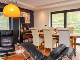 A dining room with a table and chairs at The Barn at Bryn Eithin Colwyn Bay