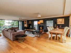 A living room with sofa and dining table at The Barn at Bryn Eithin Colwyn Bay