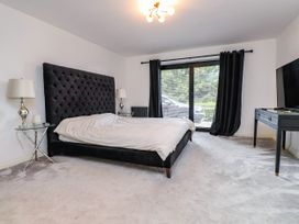 A bedroom with a bed and television at The Barn at Bryn Eithin in Colwyn Bay