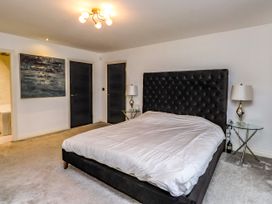 A bedroom with a bed and lamps at The Barn at Bryn Eithin in Colwyn Bay