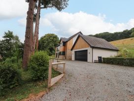 A house with a garage and driveway at The Barn at Bryn Eithin Colwyn Bay